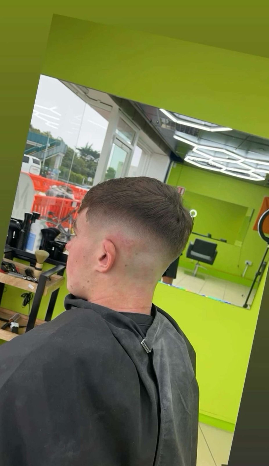 Inside M Barber Bray: lime-green walls, hexagonal ceiling lights and a skin fade in the chair